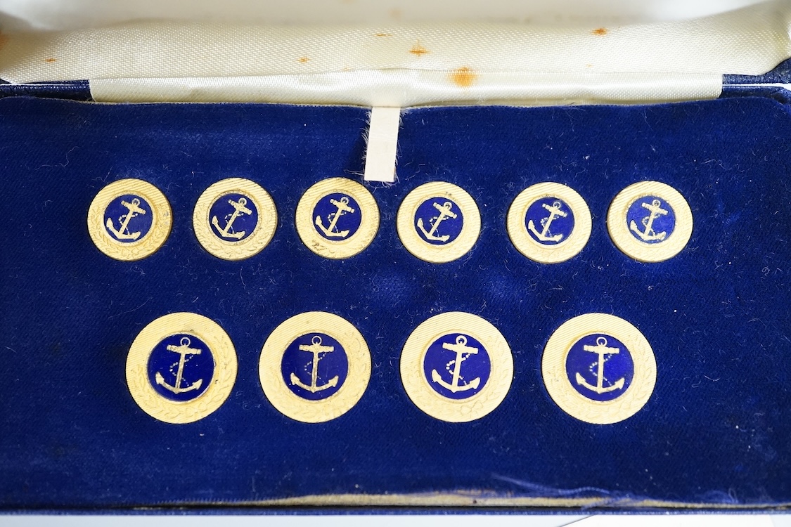 A cased set of enamelled naval buttons and similar keyrings